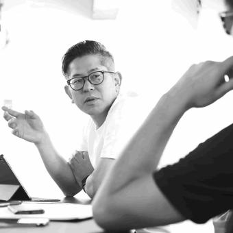 Two coworkers in discussion in office